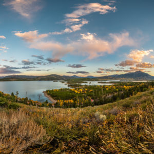 Vibrant sunset over Lake Dillon with yellow fall foliage.